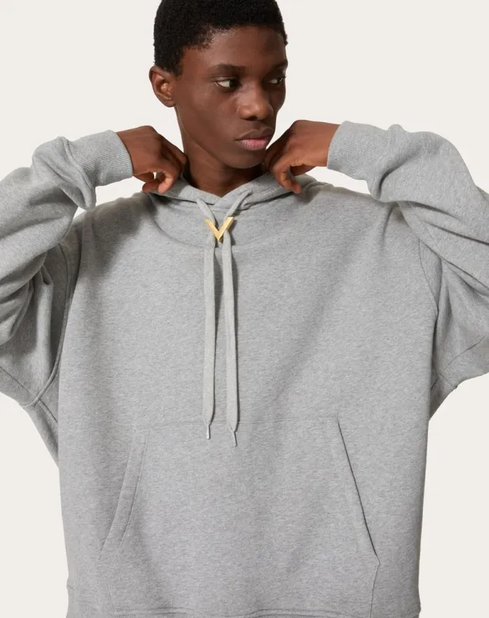 Valentino Tshirts And Sweatshirts Man Cotton Hooded Sweatshirt With Metallic V Detail For Man In Black Black Valentino Tshirts And Sweatshirts Man Cotton Hooded Sweatshirt With Metallic V Detail For Man In Black Black